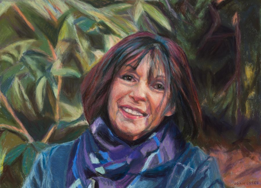 Portrait of a smiling woman with scarf.