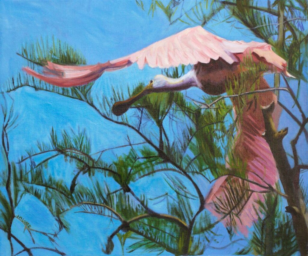Pink bird flying through blue sky.