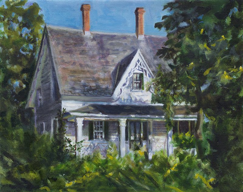 Historic house surrounded by lush greenery.