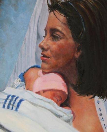 Mother holding newborn baby in hospital.
