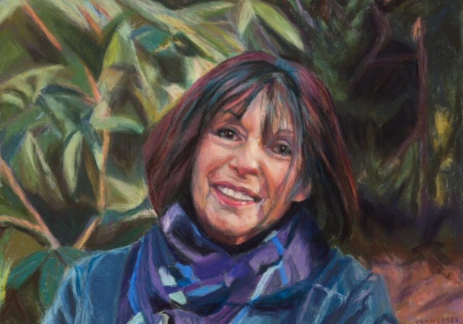 Portrait of a smiling woman with scarf.