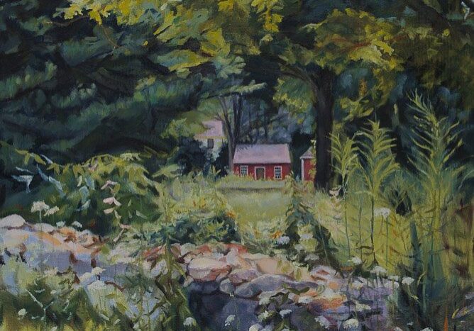 Red cottage surrounded by trees and greenery.