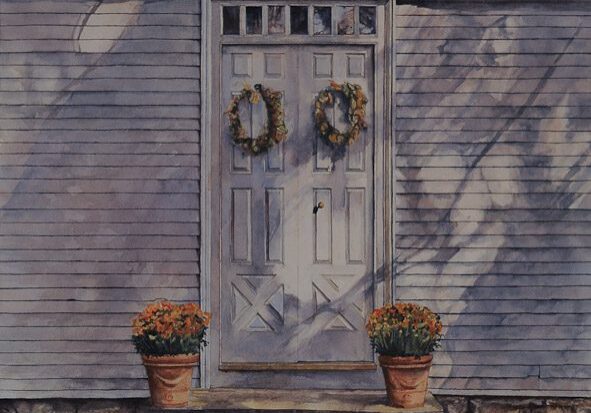 White door with wreaths and potted plants.