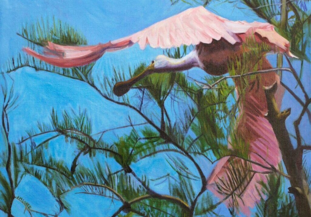 Pink bird flying through blue sky.