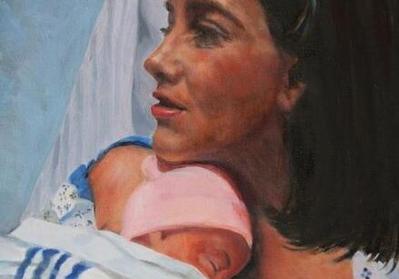 Mother holding newborn baby in hospital.