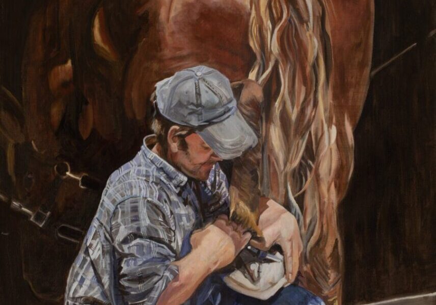 Man shoeing horse, wearing cap and plaid shirt.